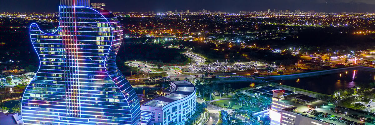 Aeried view of the guitar-shaped Hard Rock International hotel illuminated at night